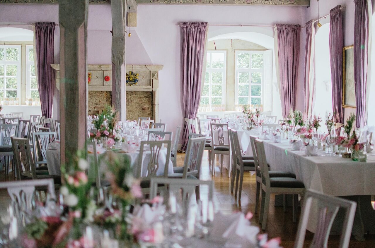 Luxurious wedding reception table setup with crystal glassware and elegant floral centerpieces